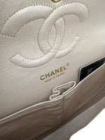 Load image into Gallery viewer, Close-up of a Chanel handbag with logo and 'Made in France' label.
