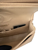 Load image into Gallery viewer, Close-up of a beige Chanel handbag with a card holder inside.
