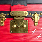 将图片加载到图库查看器，Close-up of a red Louis Vuitton suitcase with gold hardware.
