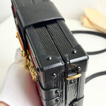 将图片加载到图库查看器，Close-up of a black leather handbag with gold accents on a white background
