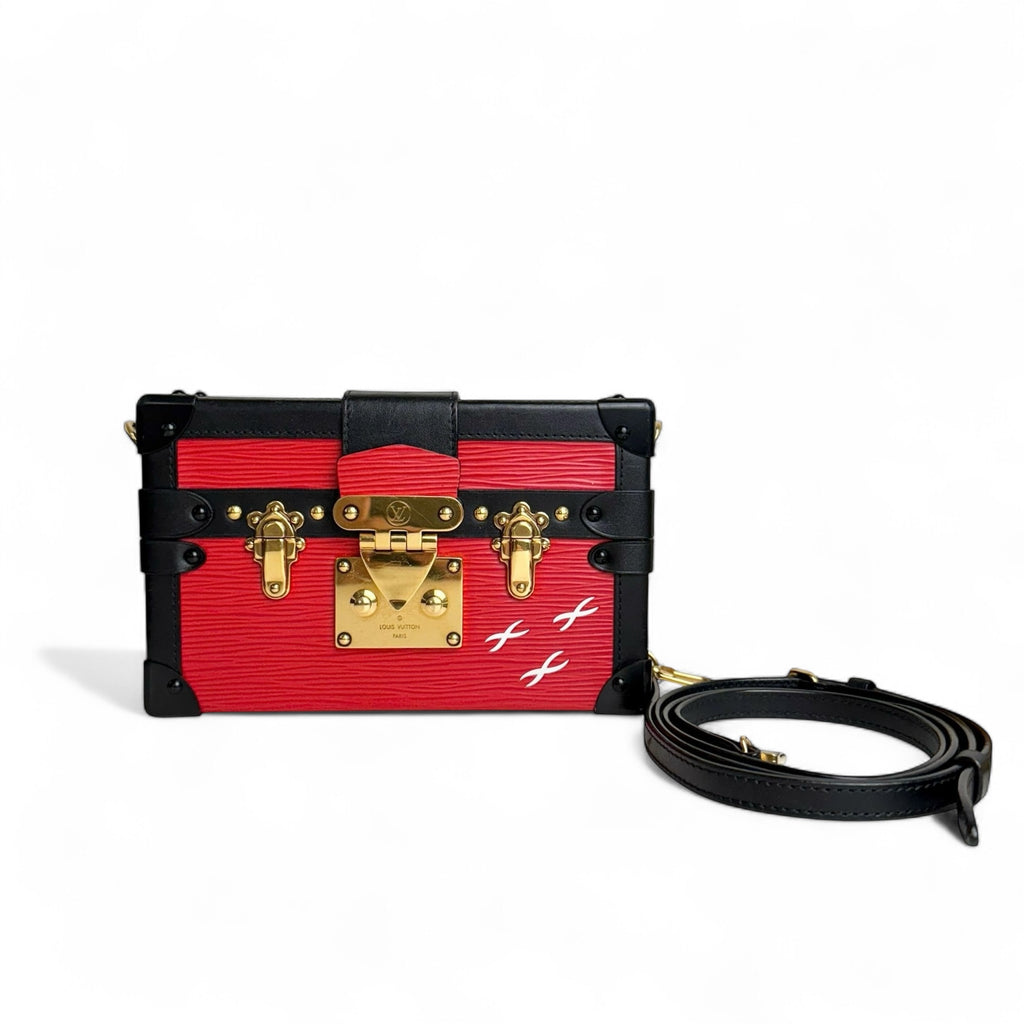 Red and black handbag with gold accents on a white background
