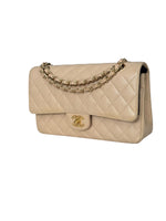 Load image into Gallery viewer, Beige quilted handbag with gold chain and logo on a white background
