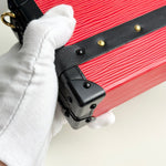 将图片加载到图库查看器，Red suitcase with a black handle being held by a gloved hand on a white background
