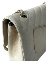 Load image into Gallery viewer, Close-up of a light gray quilted handbag with a gold chain strap on a white background
