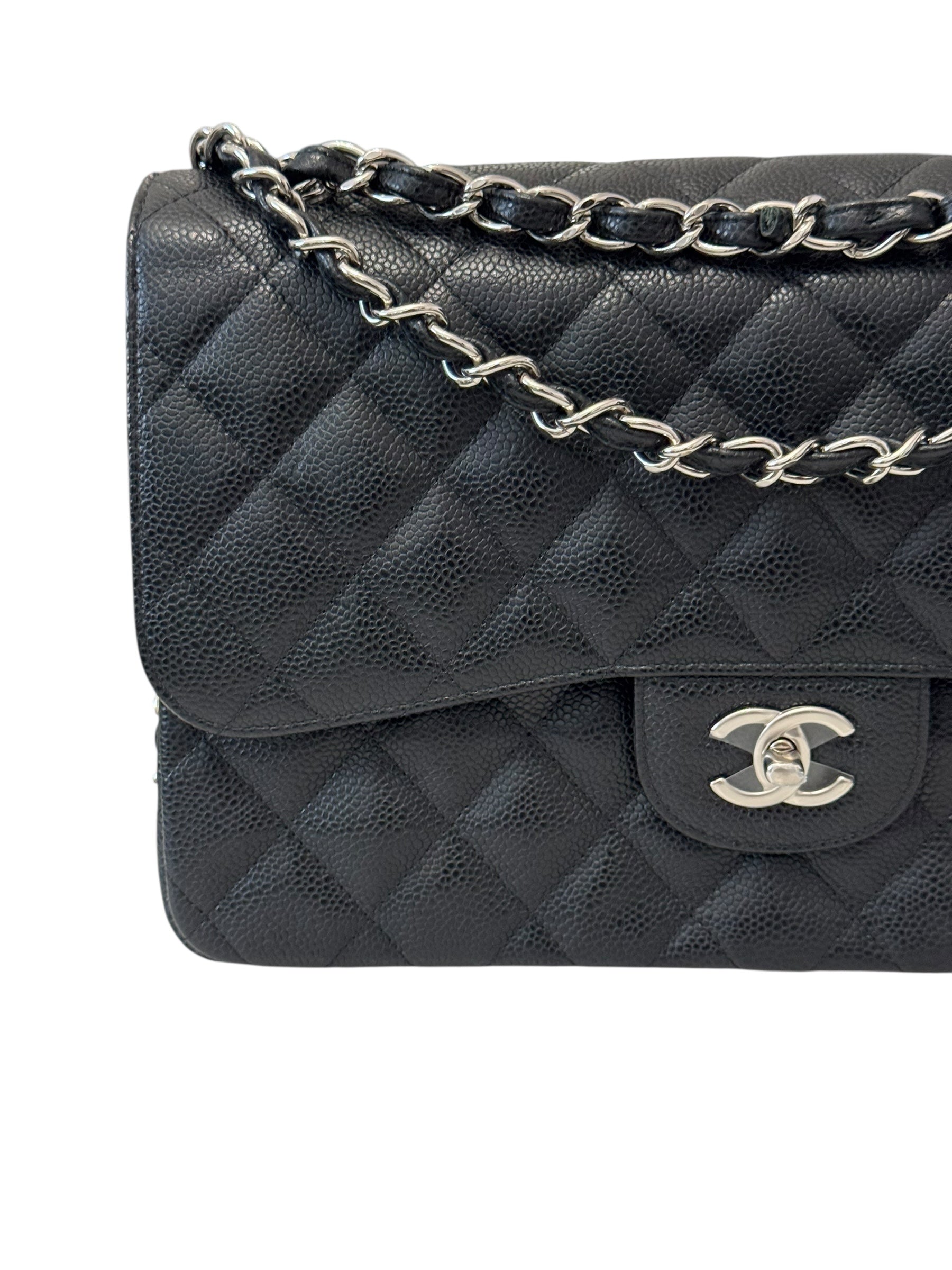 Black quilted handbag with silver chain strap on a white background