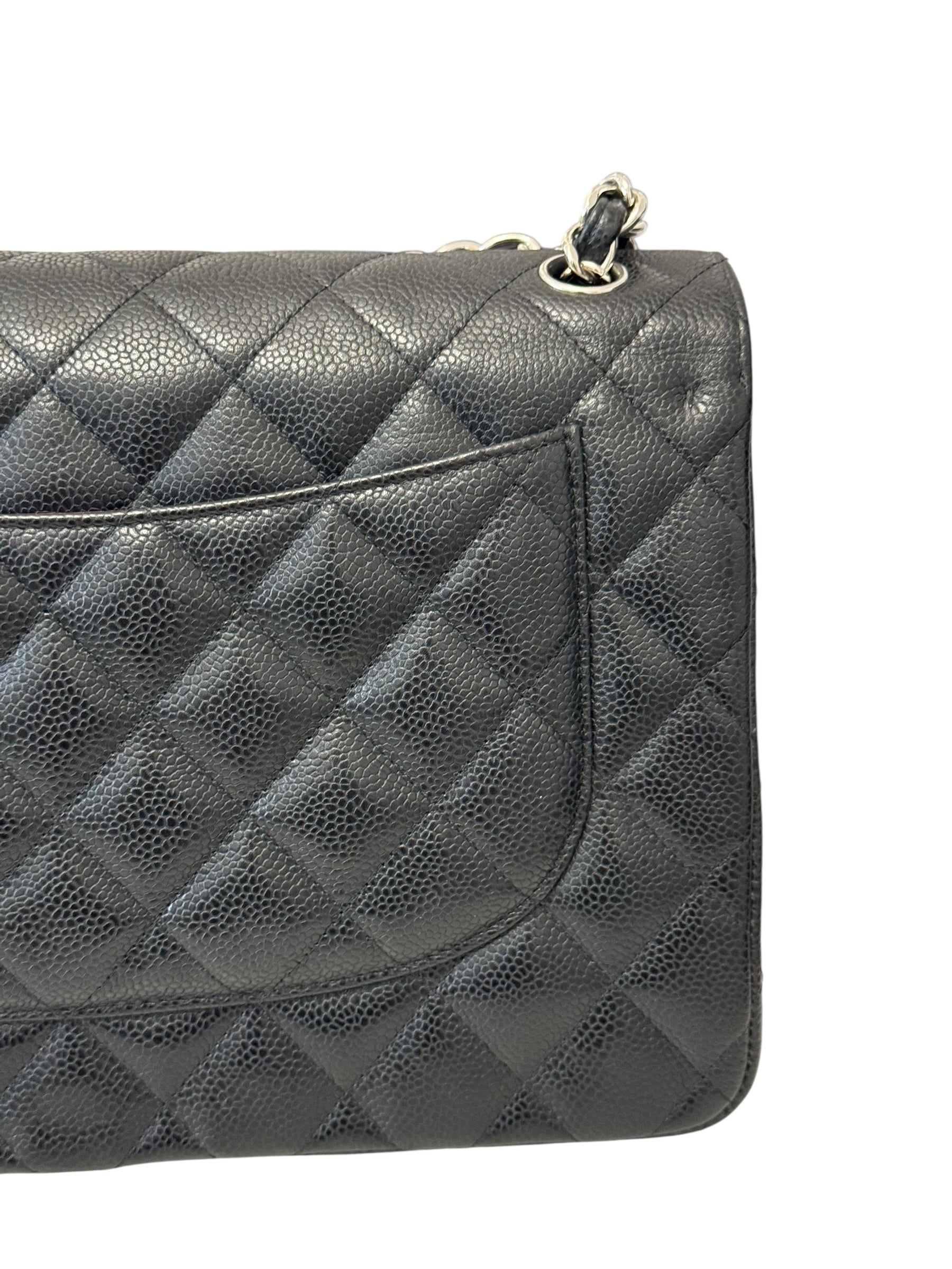 Quilted black handbag on a white background