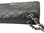 将图片加载到图库查看器，Black quilted handbag with silver chain strap on a white background
