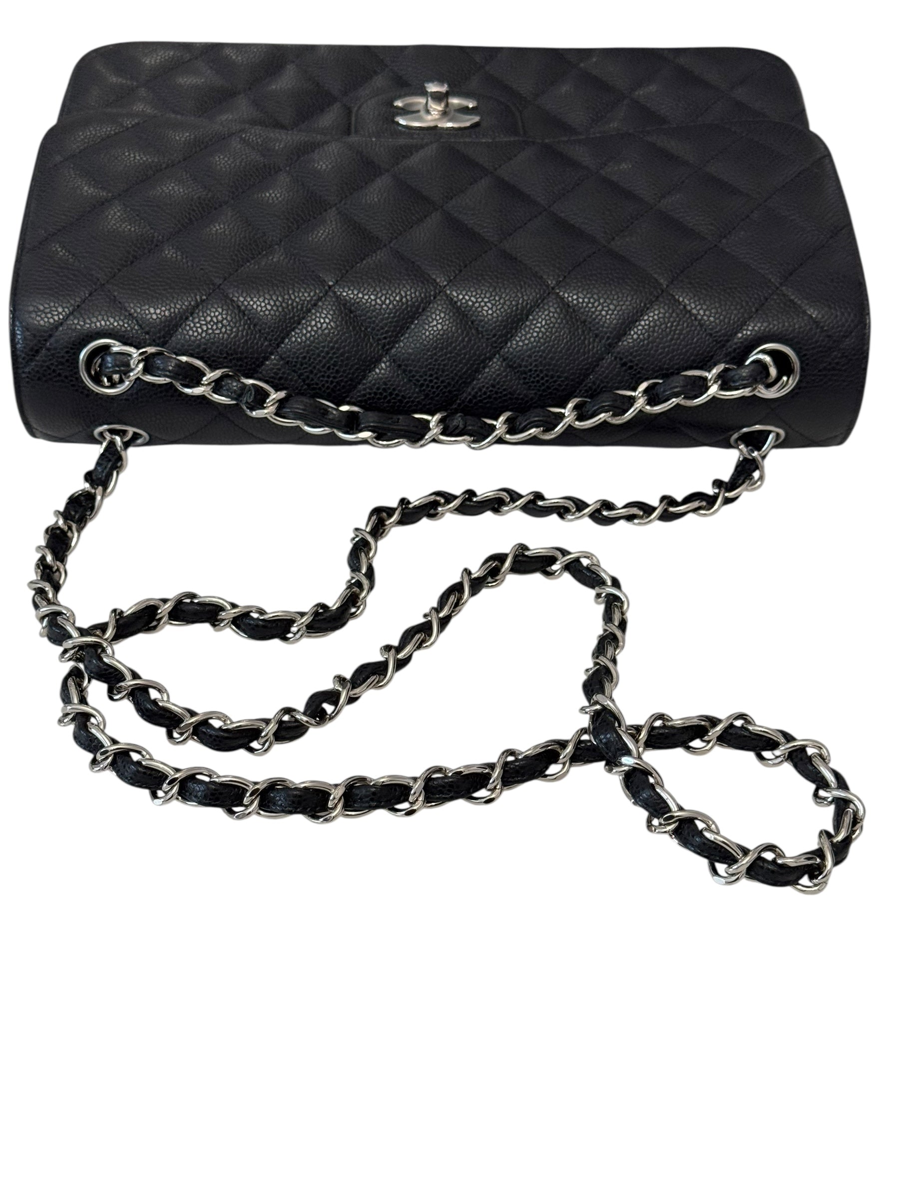 Black quilted handbag with a chain strap on a white background
