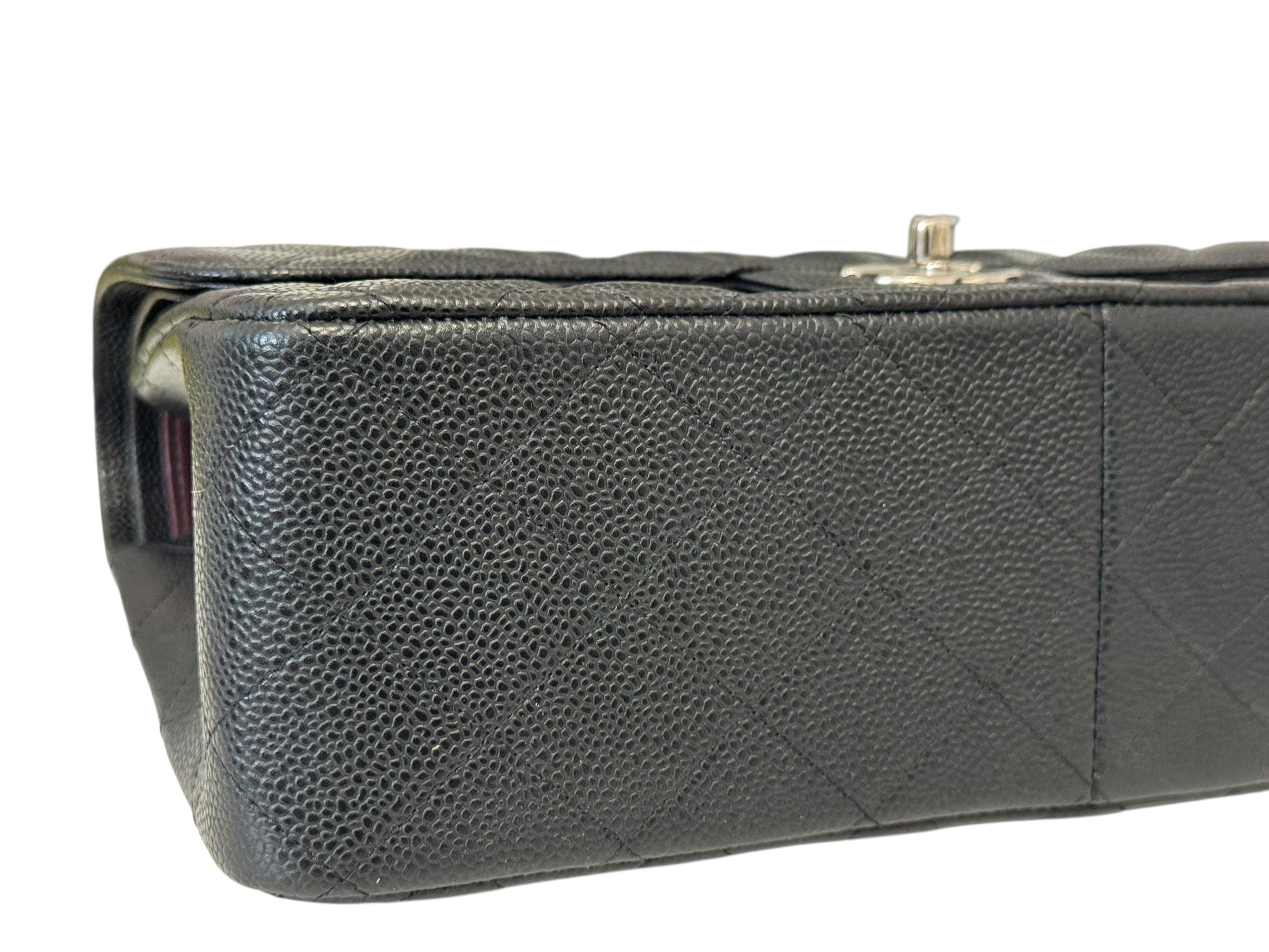 Close-up of a black quilted handbag on a white background