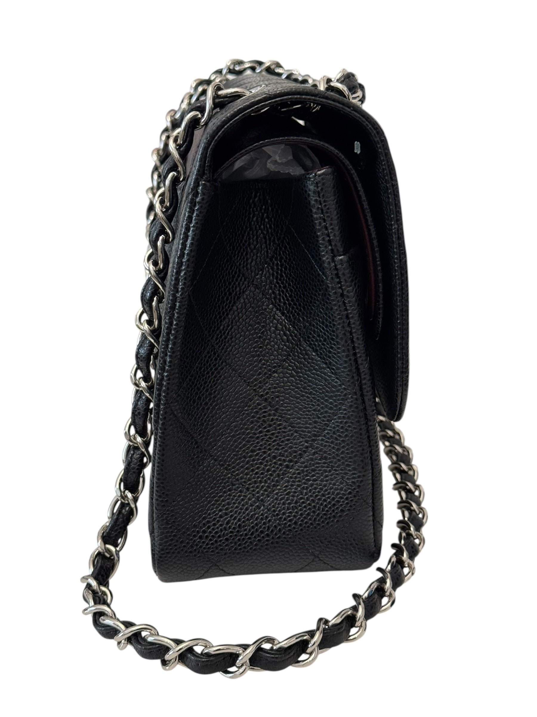 Black quilted handbag with a chain detail on a white background