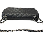 将图片加载到图库查看器，Black quilted handbag with silver chain strap on a white background
