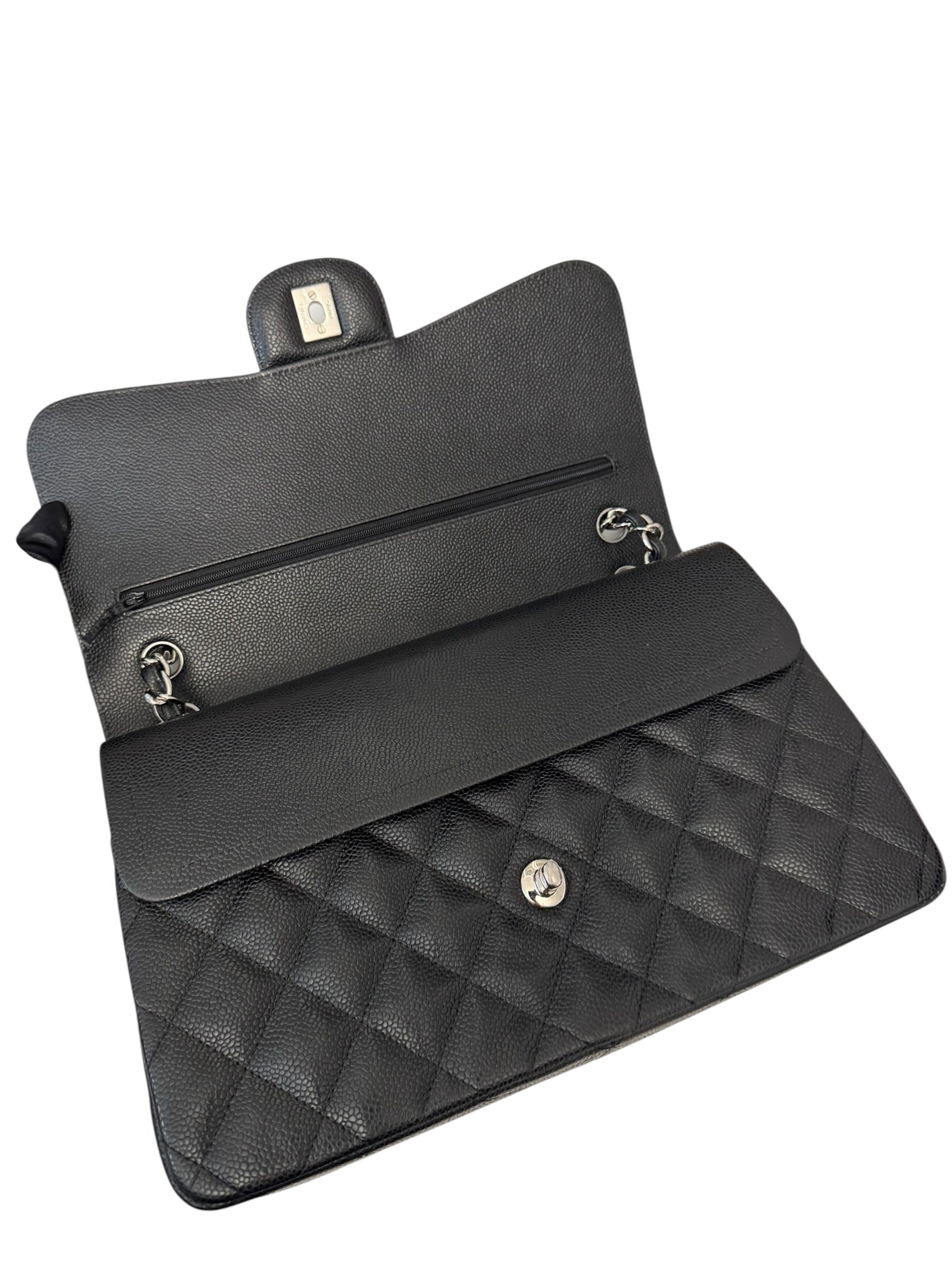 Black quilted handbag with gold hardware on a white background