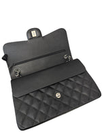 将图片加载到图库查看器，Black quilted handbag with gold hardware on a white background
