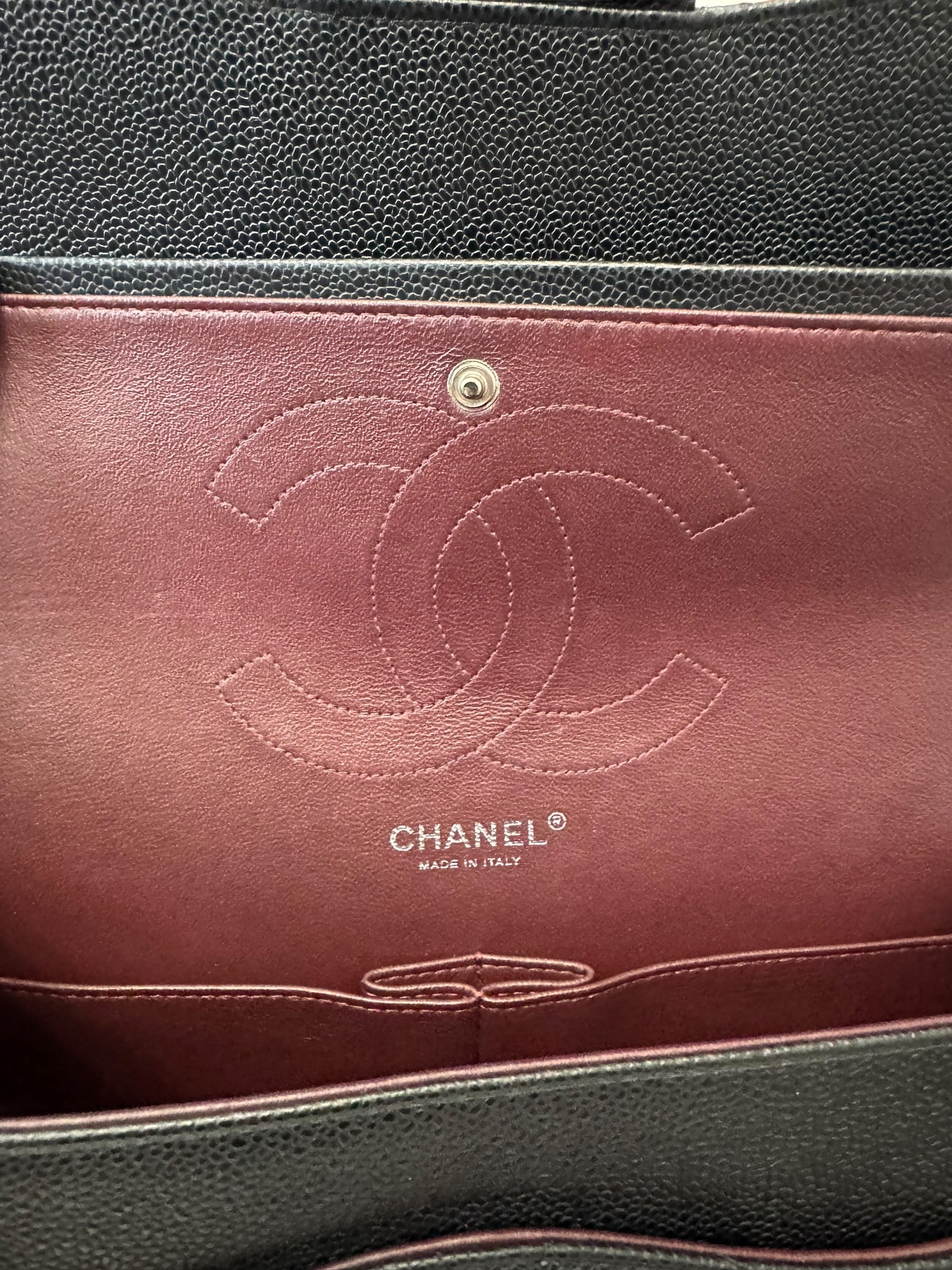 Close-up of a Chanel handbag with the brand logo and 'Made in Italy' text.