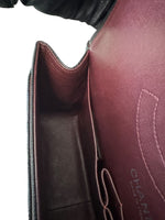 将图片加载到图库查看器，Close-up of a burgundy leather handbag with &#39;Chanel&#39; branding.
