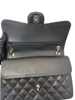将图片加载到图库查看器，Black quilted handbag held by a gloved hand on a white background
