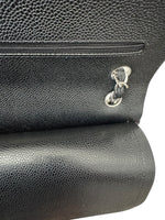 将图片加载到图库查看器，Close-up of a black leather bag with a gold clasp on a white background
