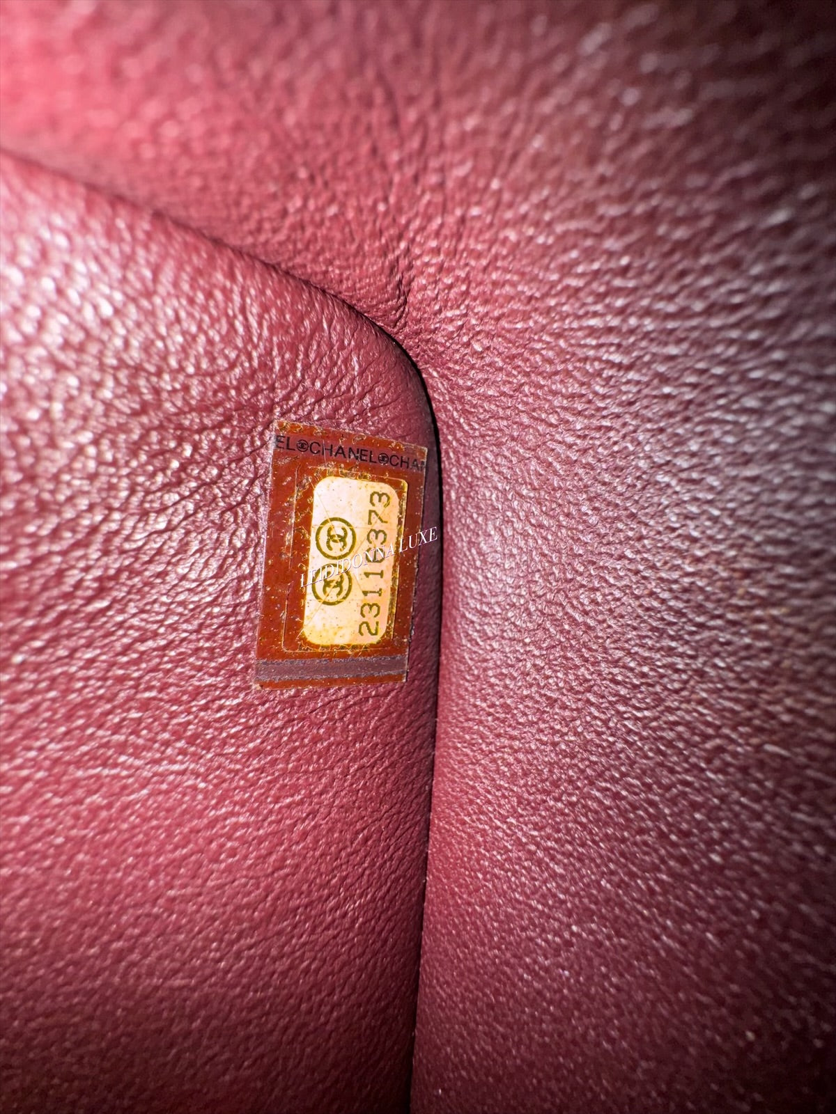 Close-up of a gold label on a textured pink surface