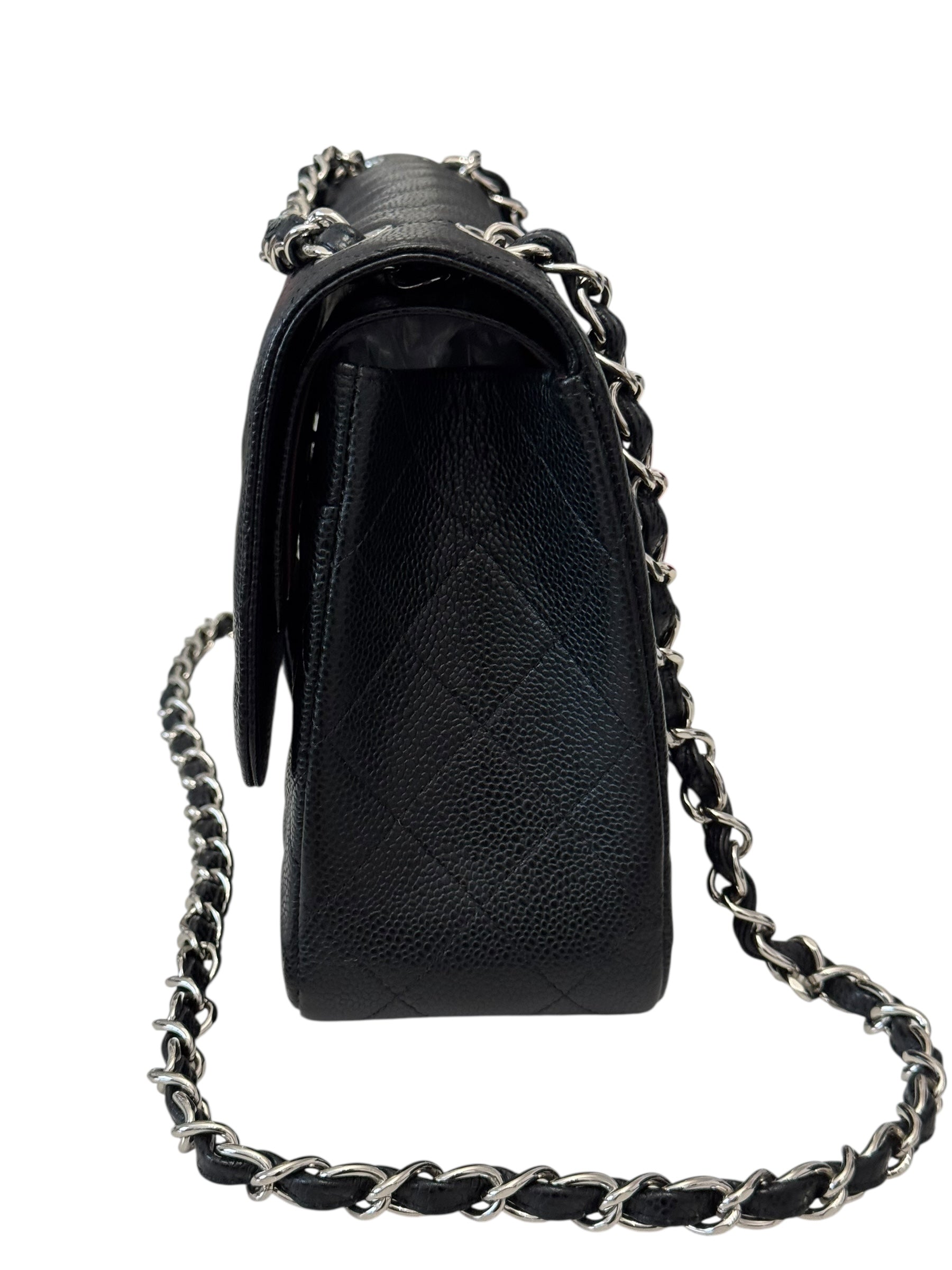 Black quilted handbag with a chain strap on a white background