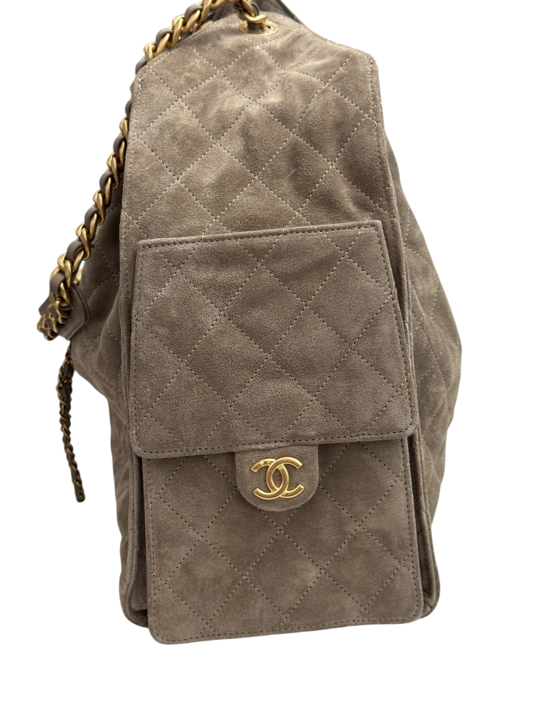 Quilted beige handbag with gold chain and logo on a white background