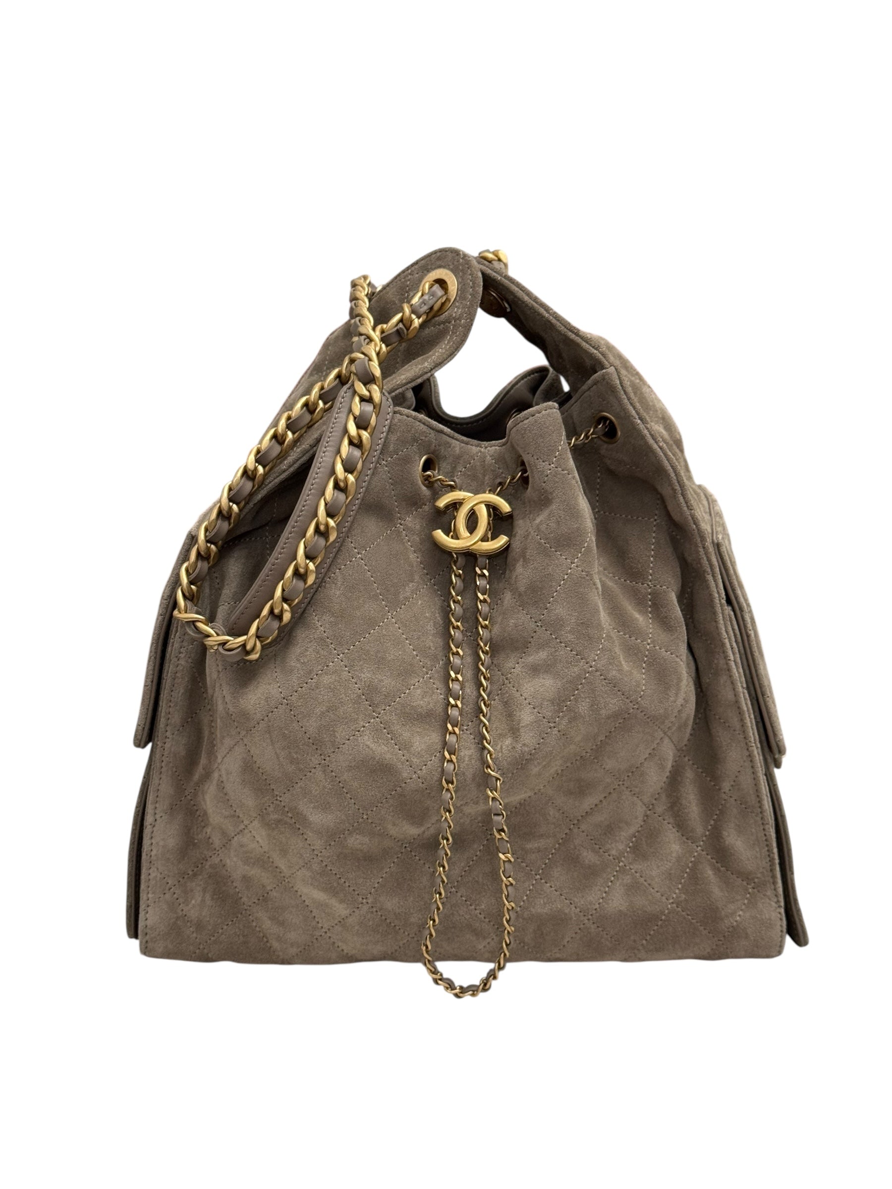Brown suede handbag with gold chain and Chanel logo on a white background