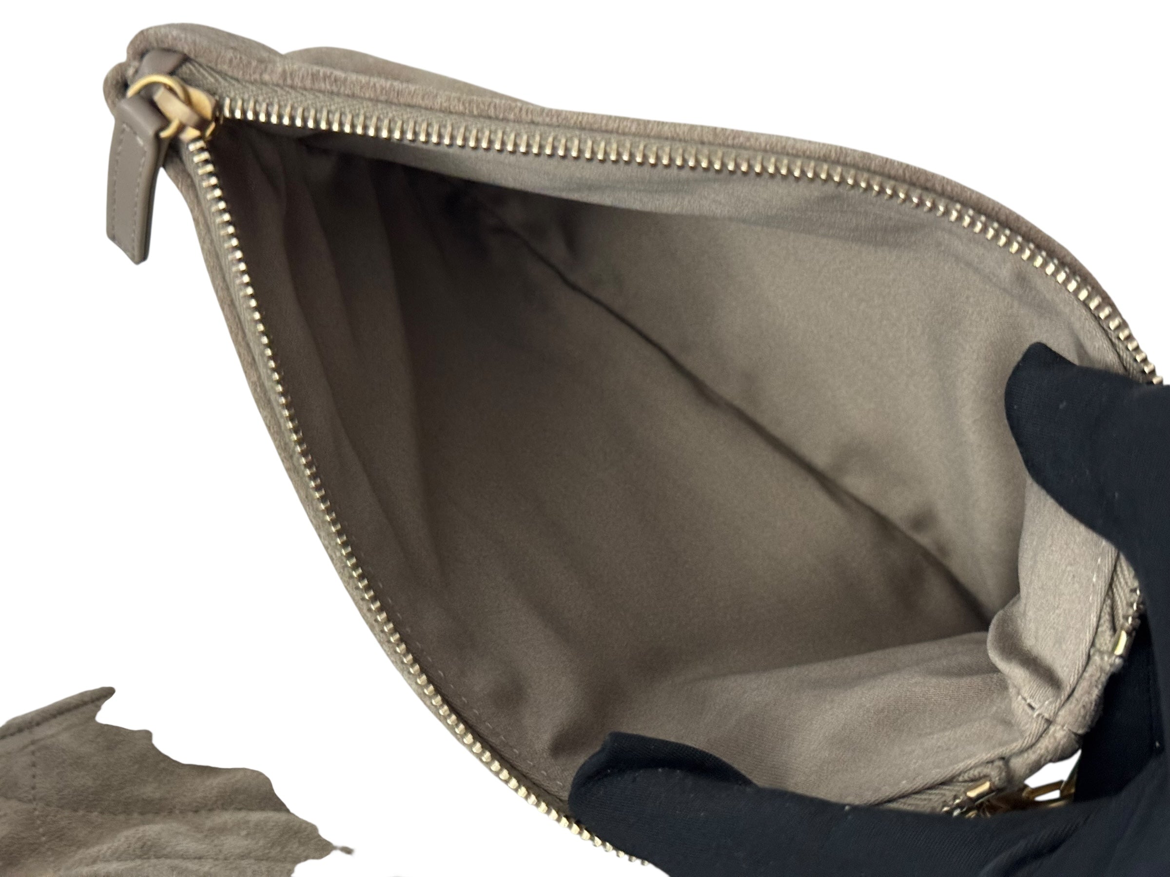 Open beige bag with a gold zipper on a white background