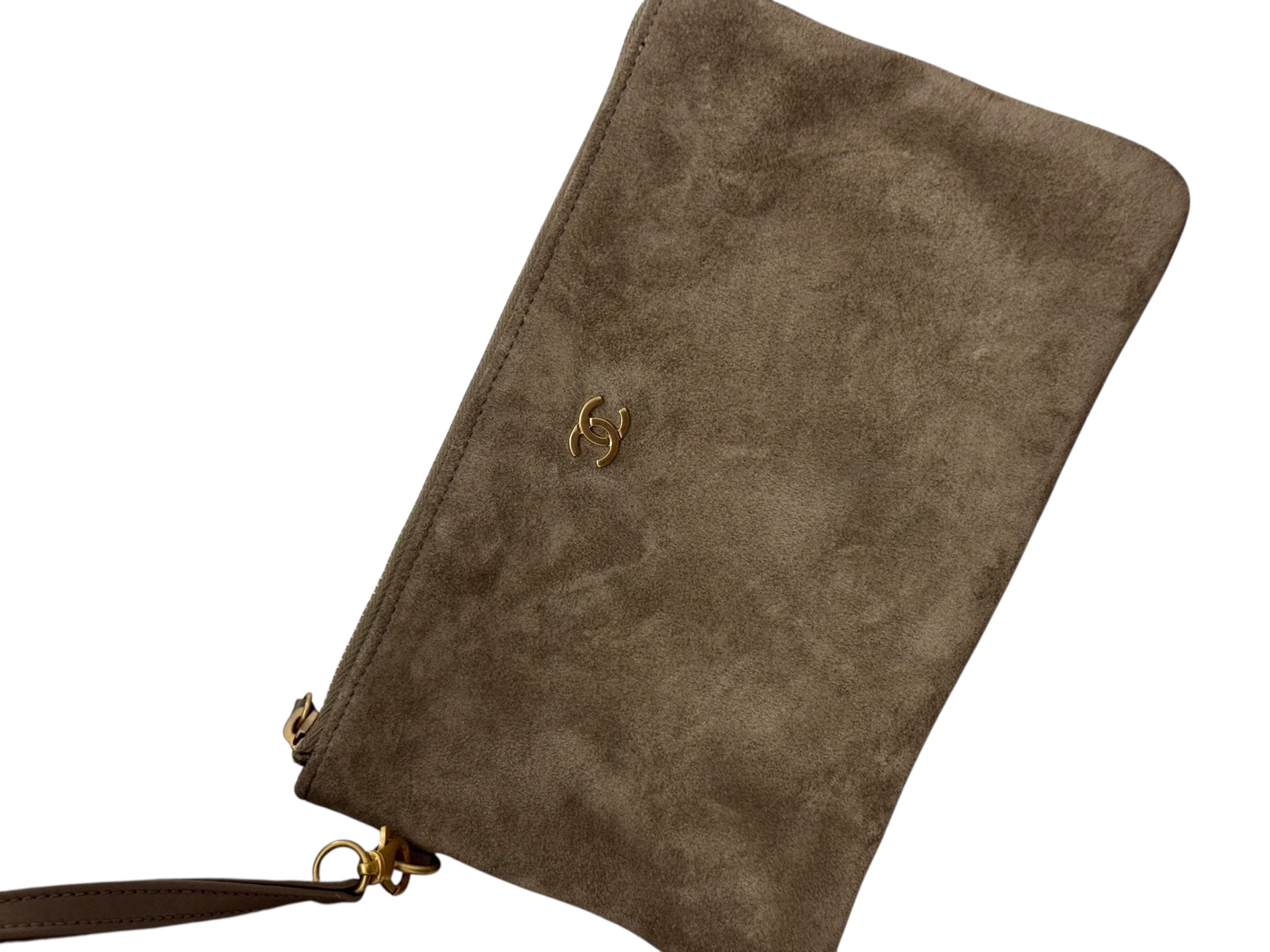 Brown suede clutch bag with a strap on a white background