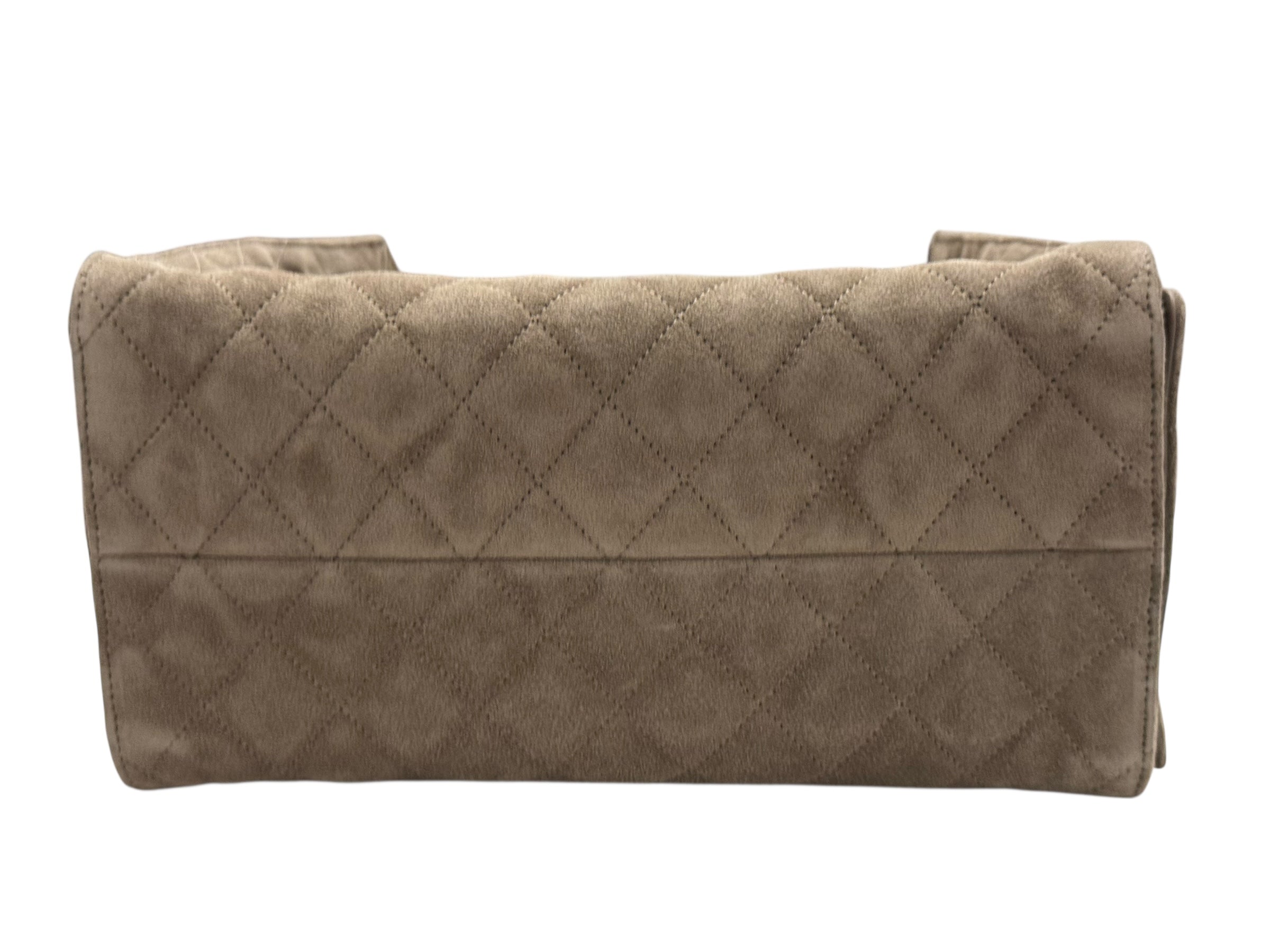 Folded quilt with diamond pattern on a white background