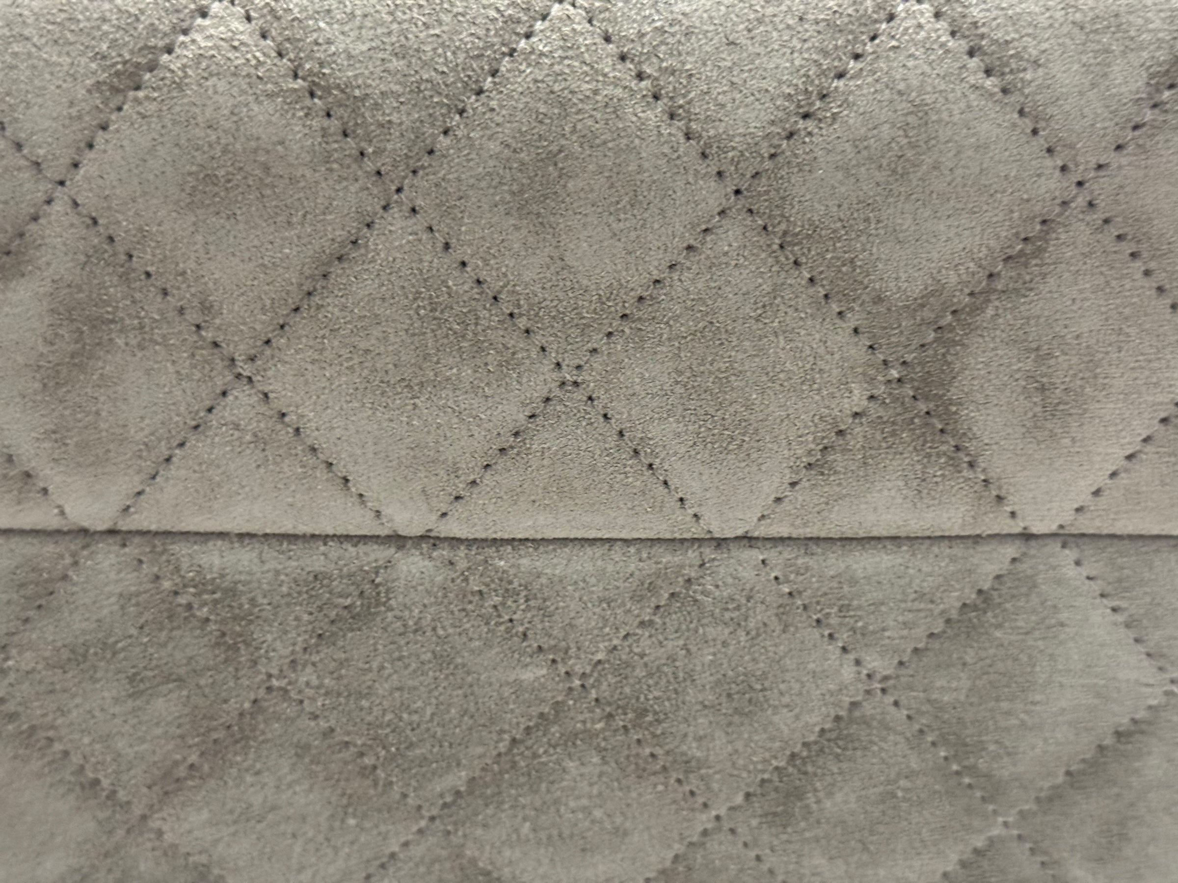 Close-up of textured quilted fabric with diamond pattern