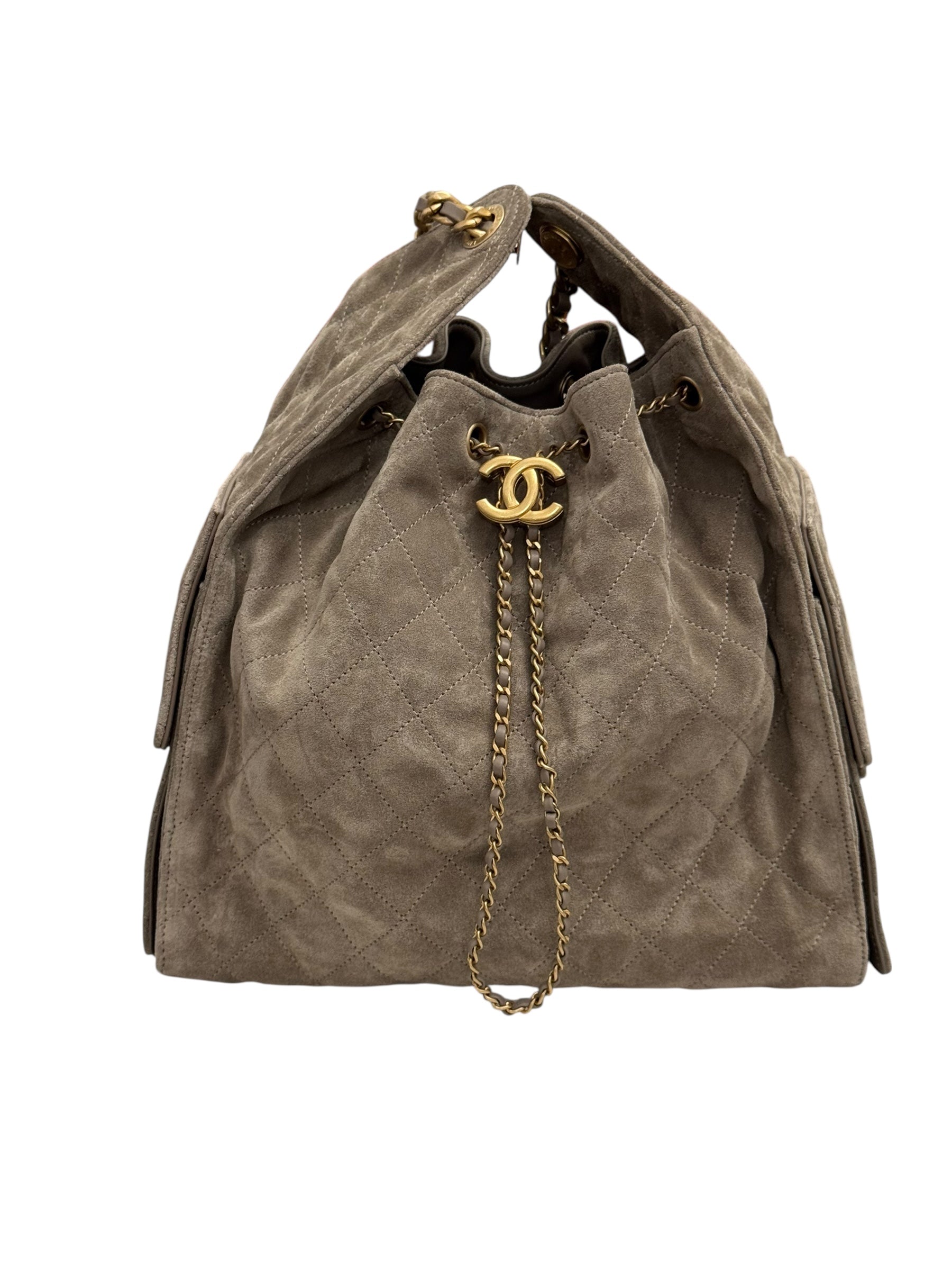 Brown suede handbag with gold chain and CC logo on a white background
