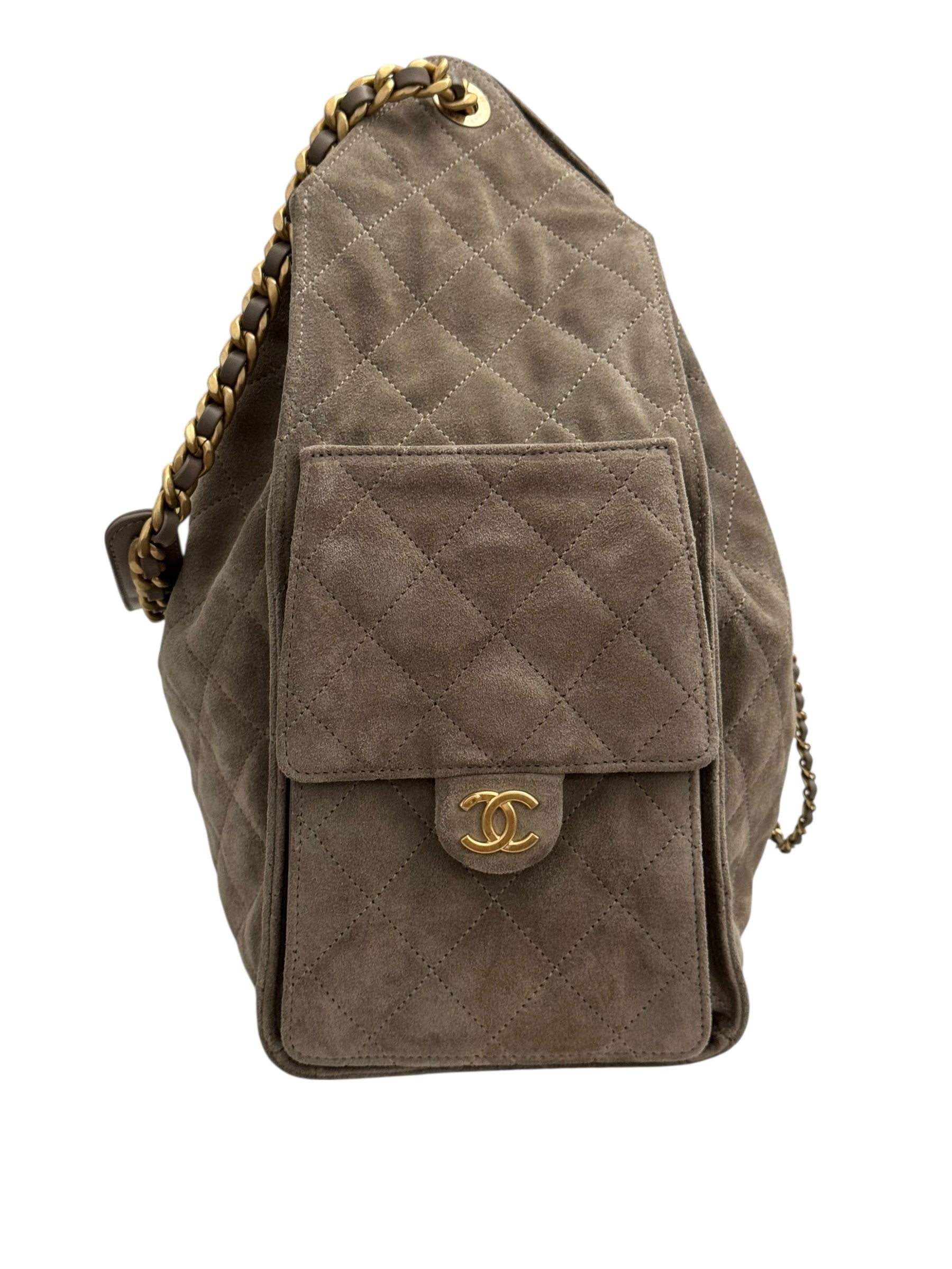 Quilted brown handbag with gold chain strap on a white background