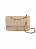 Load image into Gallery viewer, Beige quilted handbag with gold chain and CC logo on a white background
