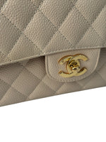 Load image into Gallery viewer, Beige quilted handbag with gold CC logo on a white background
