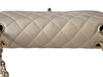 Load image into Gallery viewer, Beige quilted handbag with gold chain on a white background
