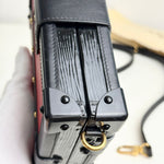 将图片加载到图库查看器，Close-up of a black leather wallet with a gold ring on a white background
