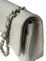 Load image into Gallery viewer, Close-up of a light gray quilted handbag with a chain detail on a white background
