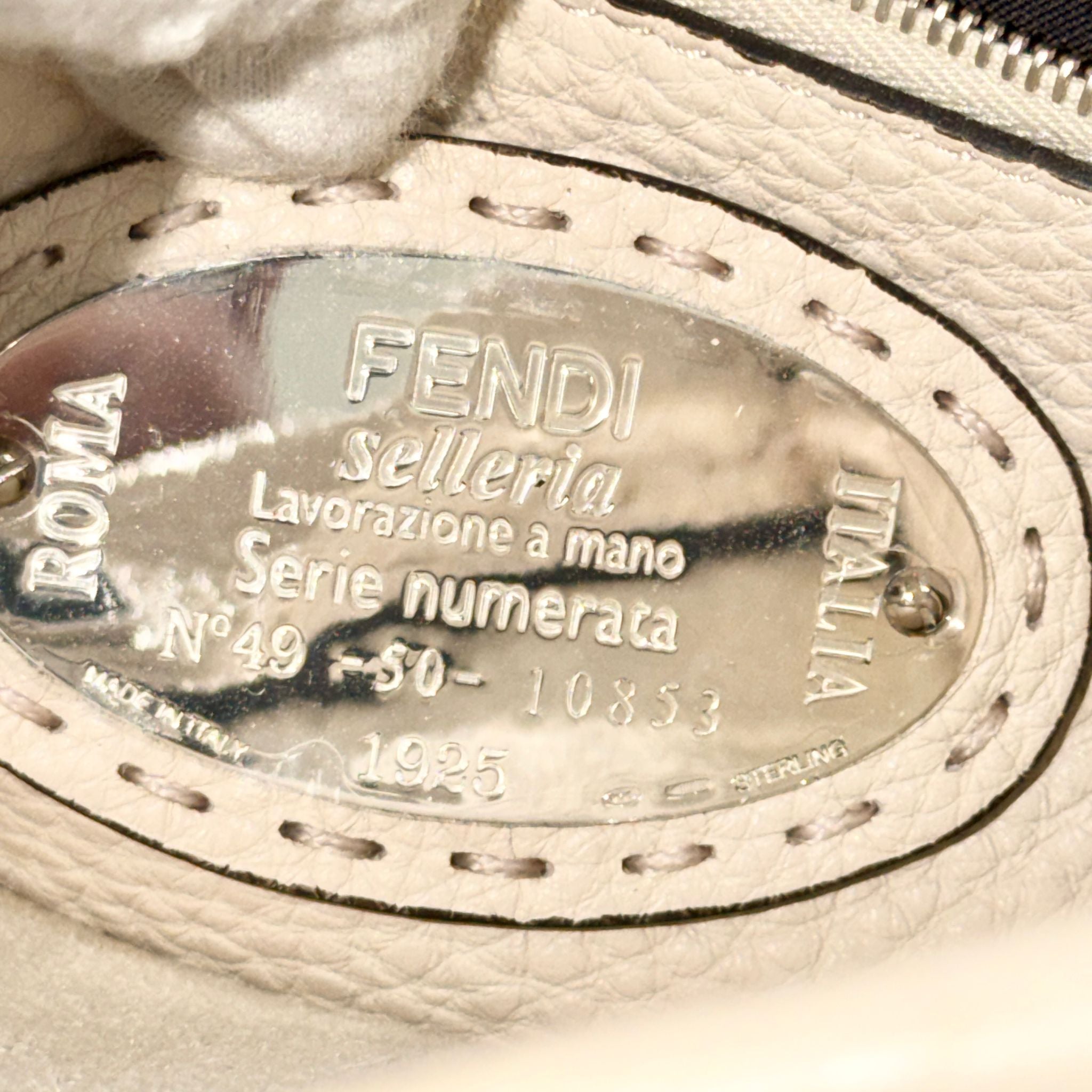 Fendi label on a leather product with 'Roma Selleria' and 'Italia' text.