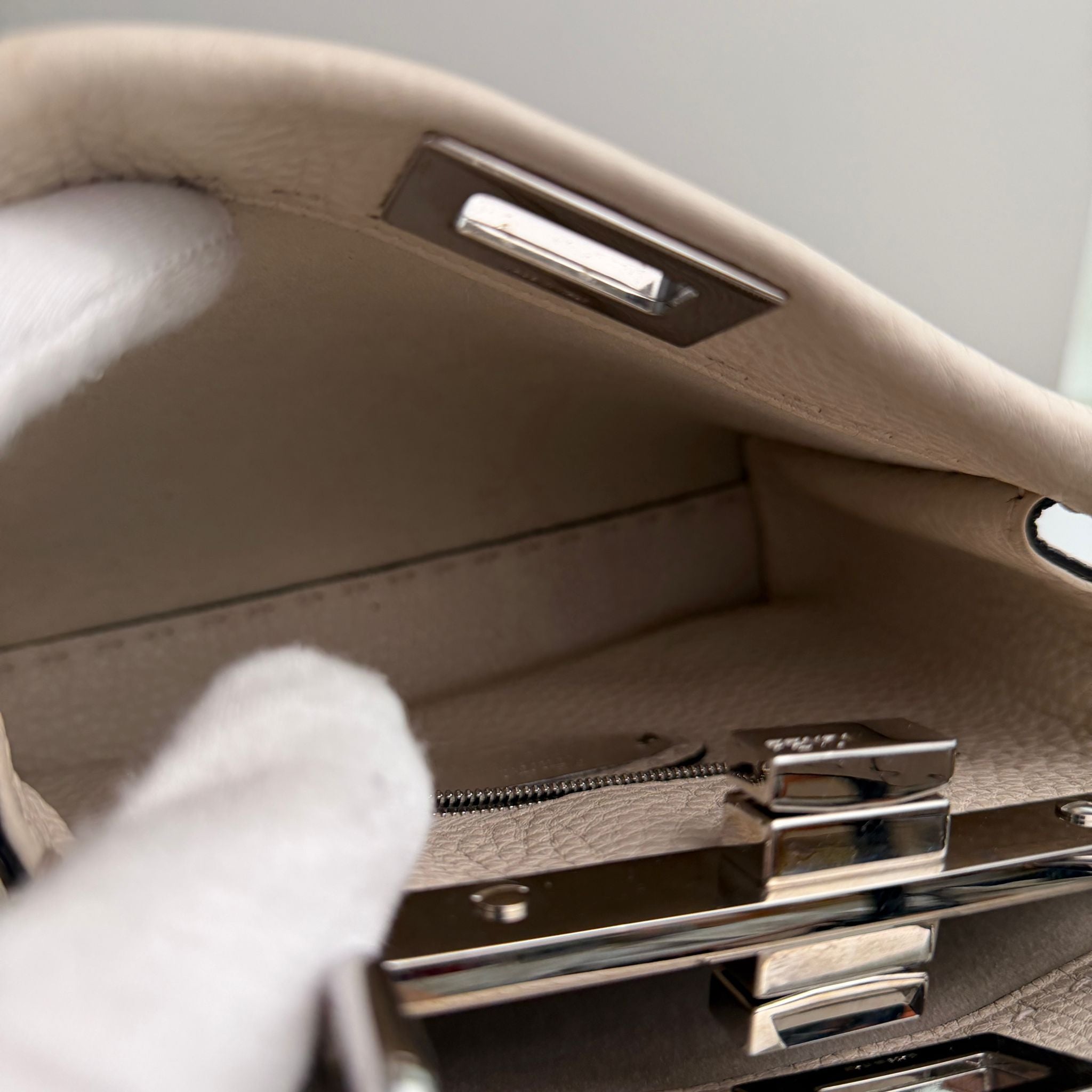 Close-up of a car's interior door panel with a hand reaching towards the handle.