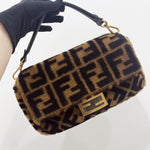 将图片加载到图库查看器，Fur-patterned handbag with gold accents held by a gloved hand on a white background
