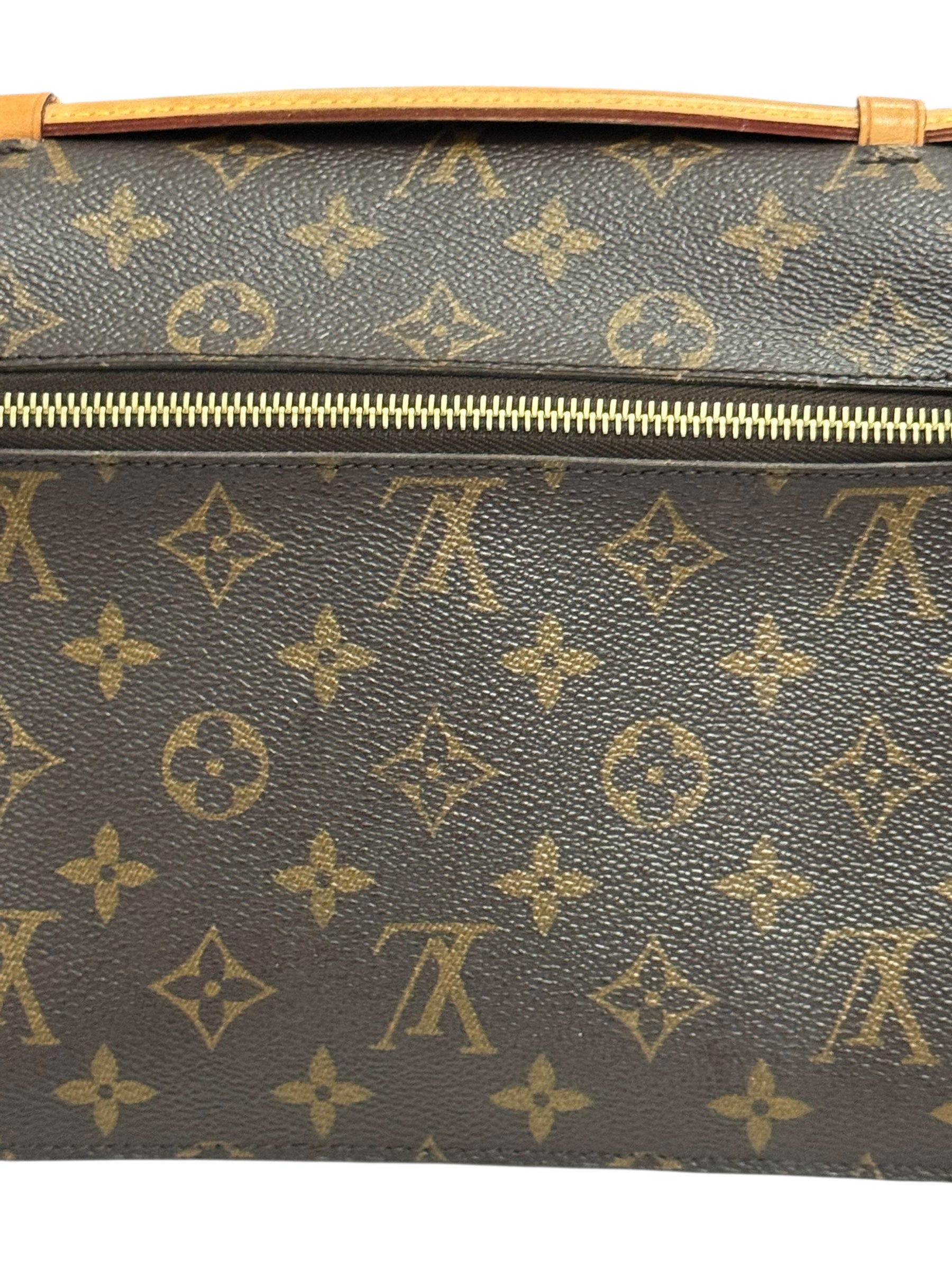 Louis Vuitton monogram handbag with gold zipper on a white background