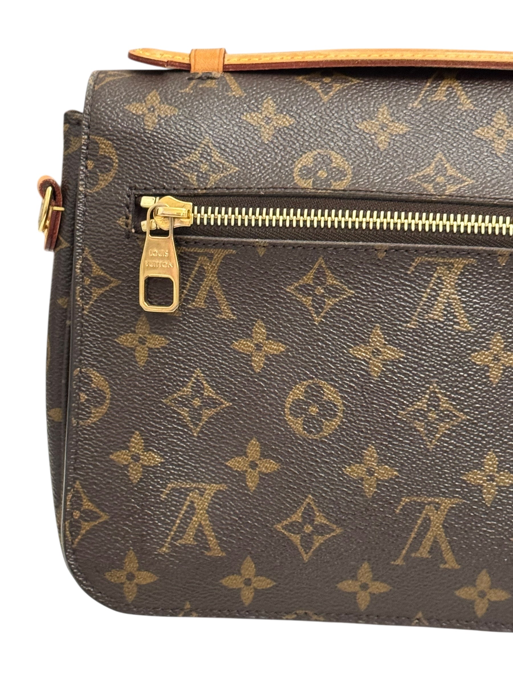 Louis Vuitton monogram handbag with gold zipper on a white background