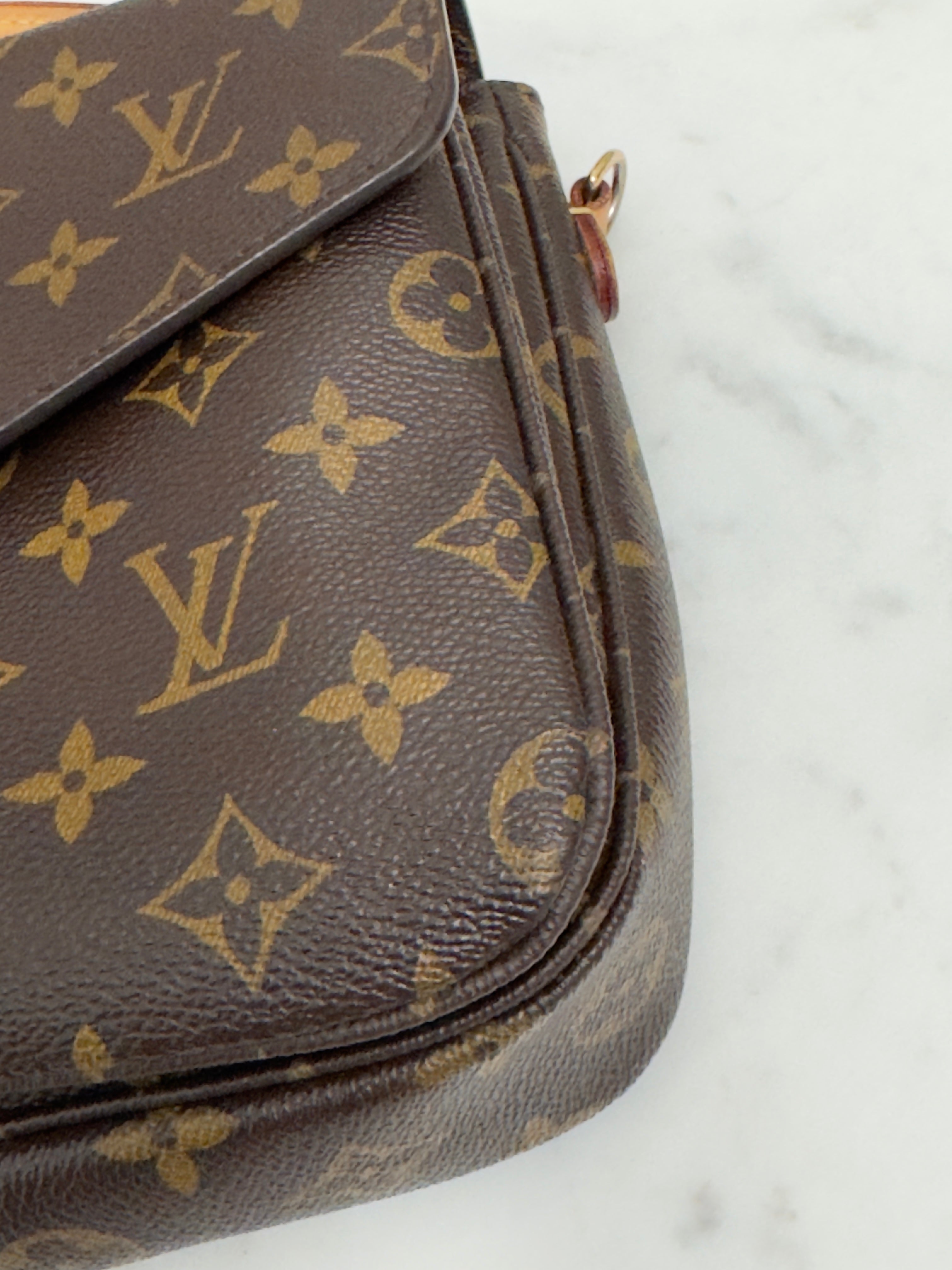 Brown Louis Vuitton bag with monogram pattern on a white background