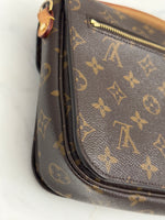 Load image into Gallery viewer, Close-up of a brown handbag with a prominent logo pattern on a white background
