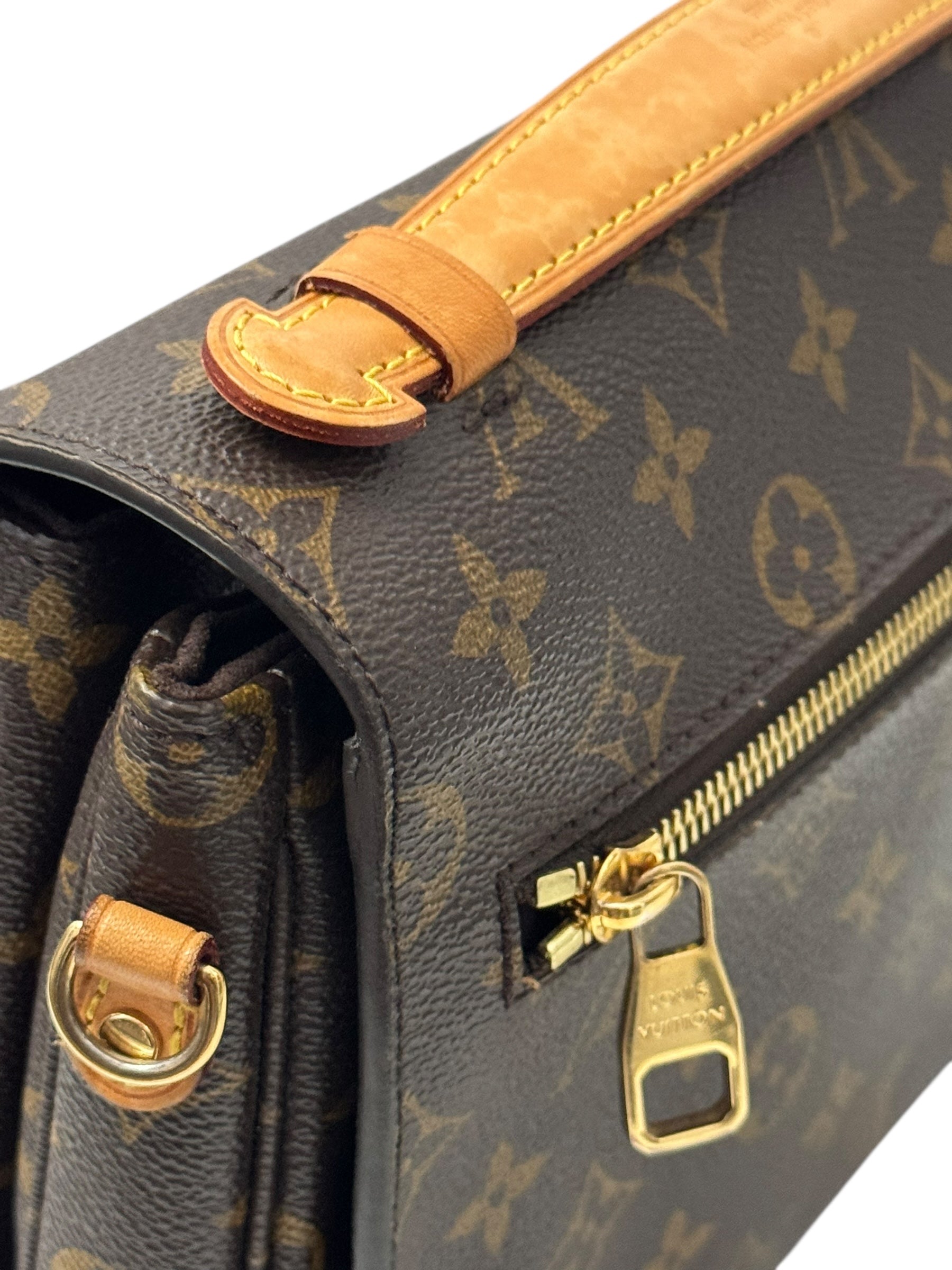 Close-up of a Louis Vuitton bag with monogram pattern and gold hardware.