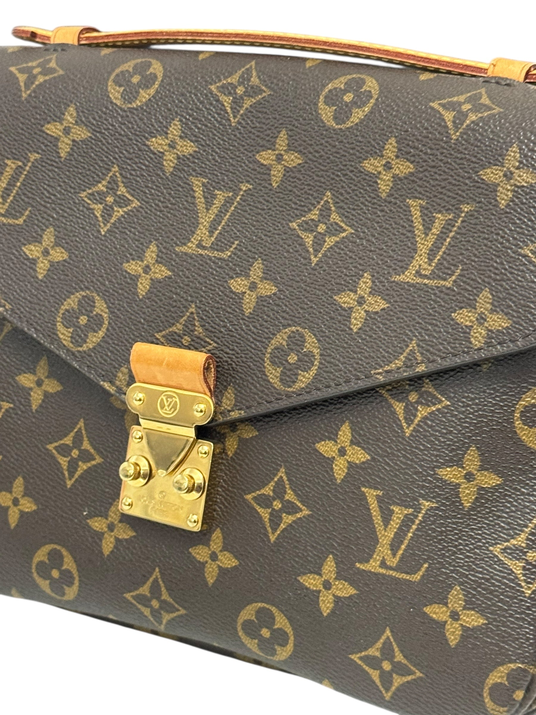 Louis Vuitton monogram handbag with gold lock on a white background