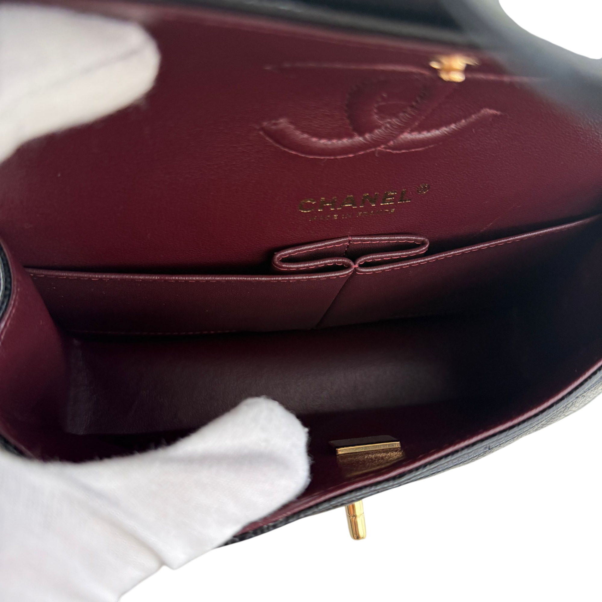 Close-up of a Chanel handbag with visible logo and gold hardware.