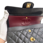 Charger l&#39;image dans la galerie, Close-up of a Chanel handbag with a quilted design and gold hardware.
