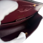 Charger l&#39;image dans la galerie, Close-up of a burgundy leather wallet with visible stitching details.
