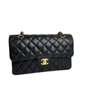 Charger l&#39;image dans la galerie, Black quilted handbag with gold hardware on a white background
