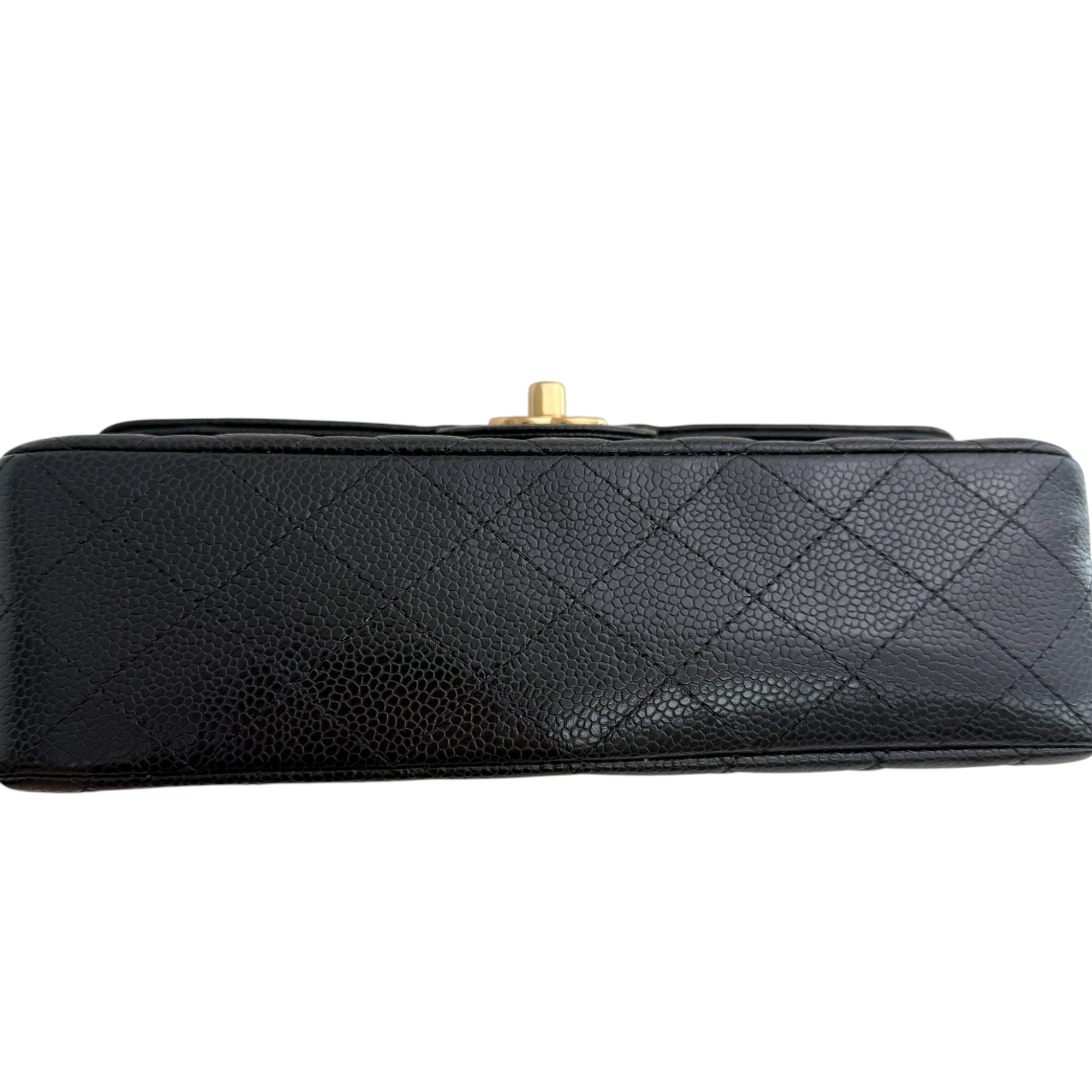 Black quilted handbag with gold clasp on a white background